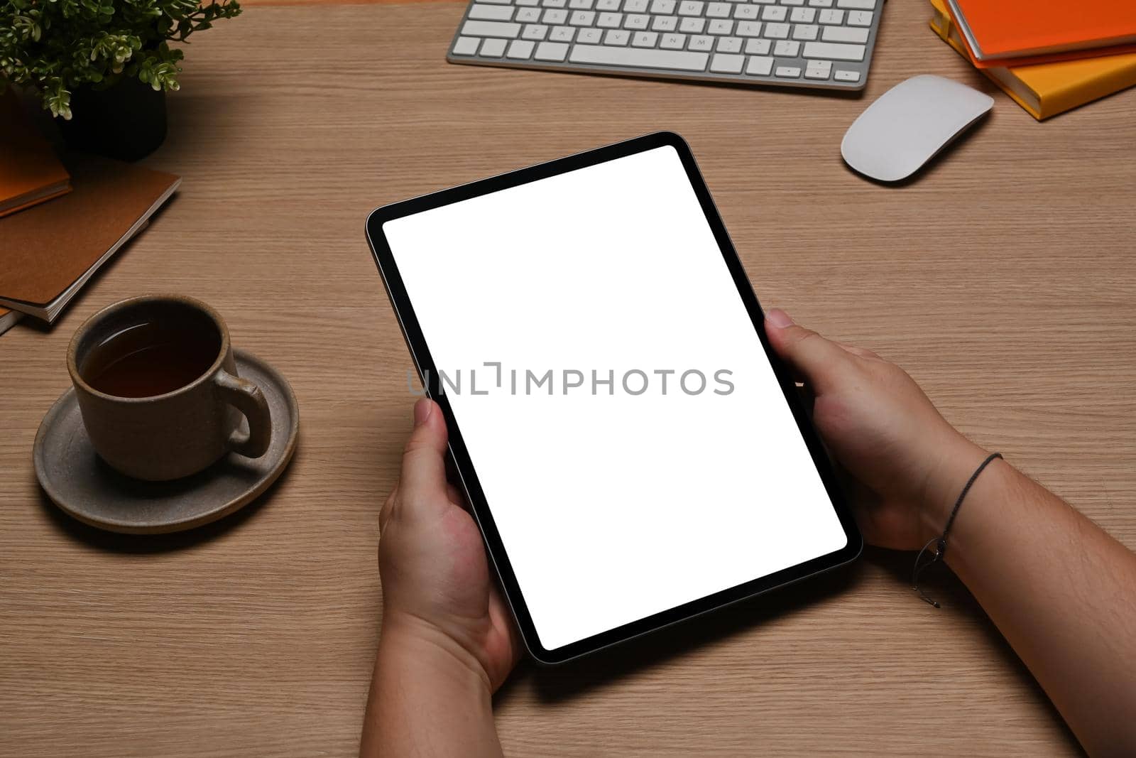 Close up man holding mock up digital tablet with blank screen. by prathanchorruangsak