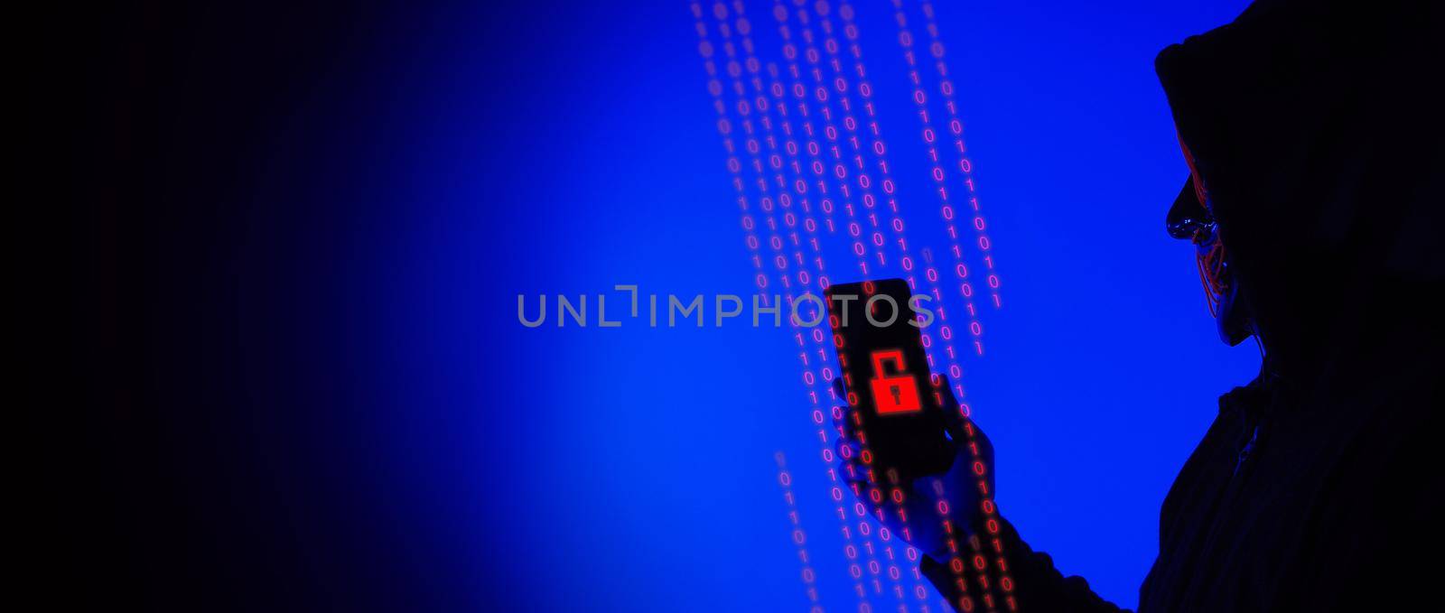 Digital security Concept. Anonymous hacker with mask holding smartphone hacked. by gnepphoto