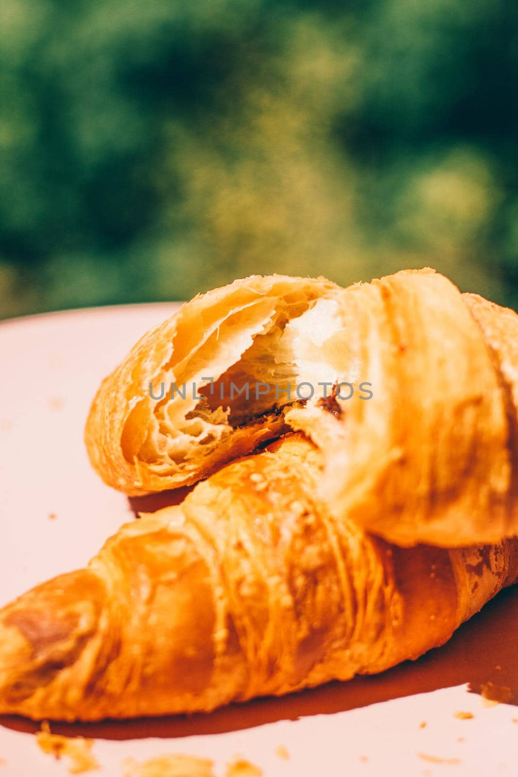 Fresh croissant, summer breakfast outdoors - sweet food, French pastry and eating outside concept. Good morning, darling