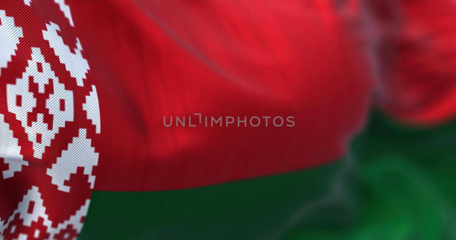 Close-up view of the belarusian national flag waving in the wind. The Republic of Belarus is a landlocked country in Eastern Europe. Fabric textured background. Selective focus