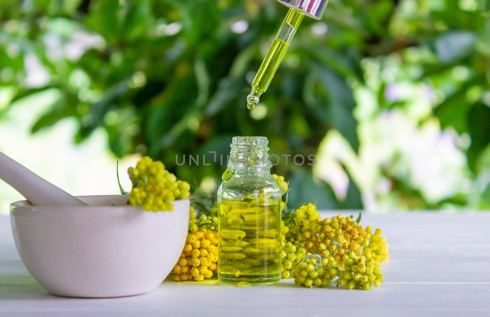 essential oil of tansy in a beautiful bottle on the table. selective focus