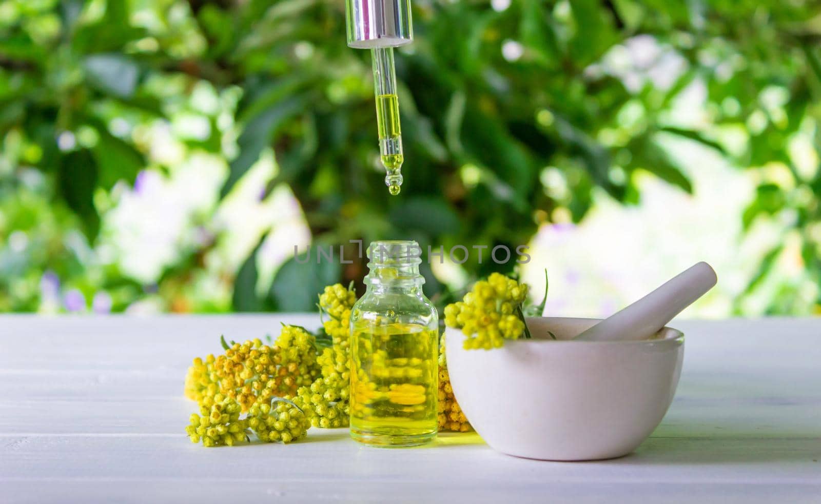 essential oil of tansy in a beautiful bottle on the table. selective focus