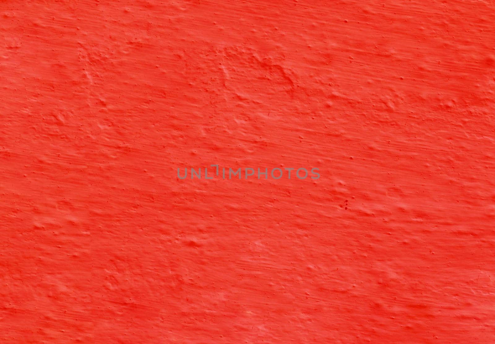 Abstract panoramic image of a red clay wall. Texture from old red uneven plaster.