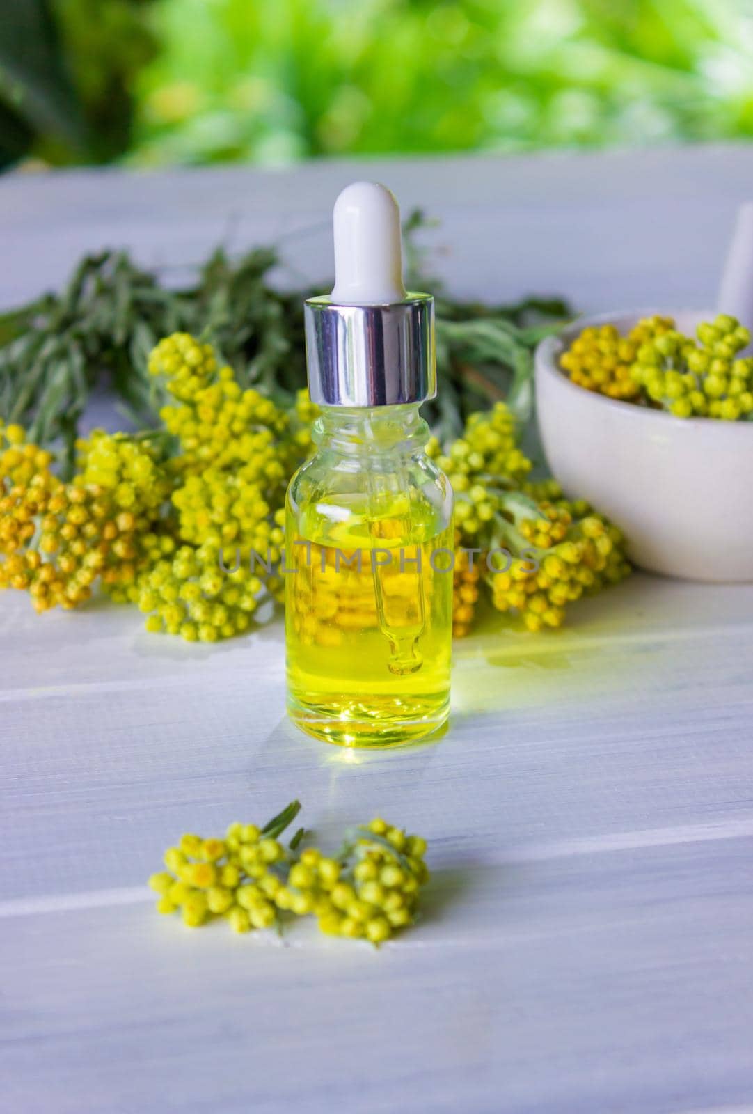 essential oil of tansy in a beautiful bottle on the table. selective focus
