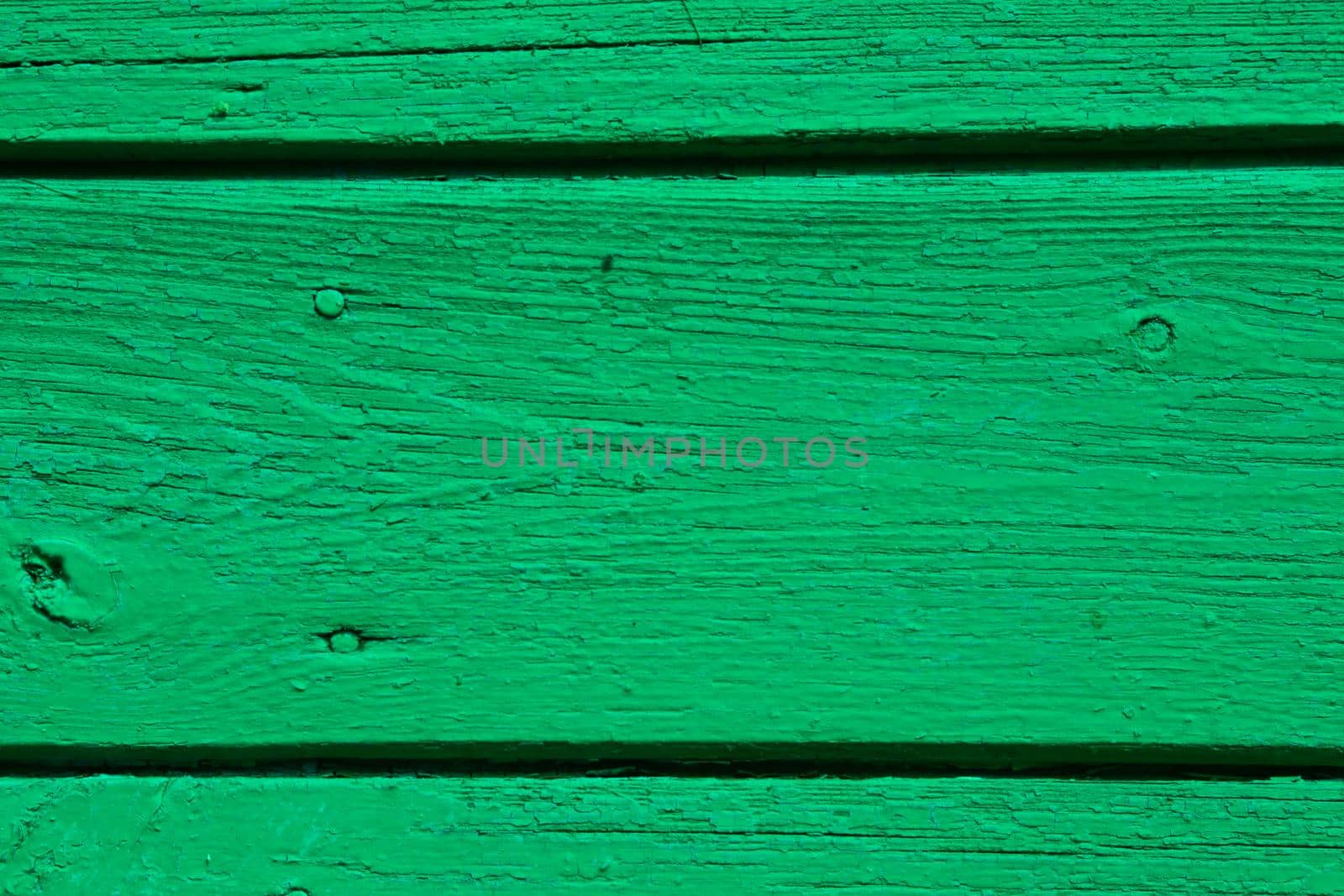 Wooden planks as background. Old paint damaged by the weather.