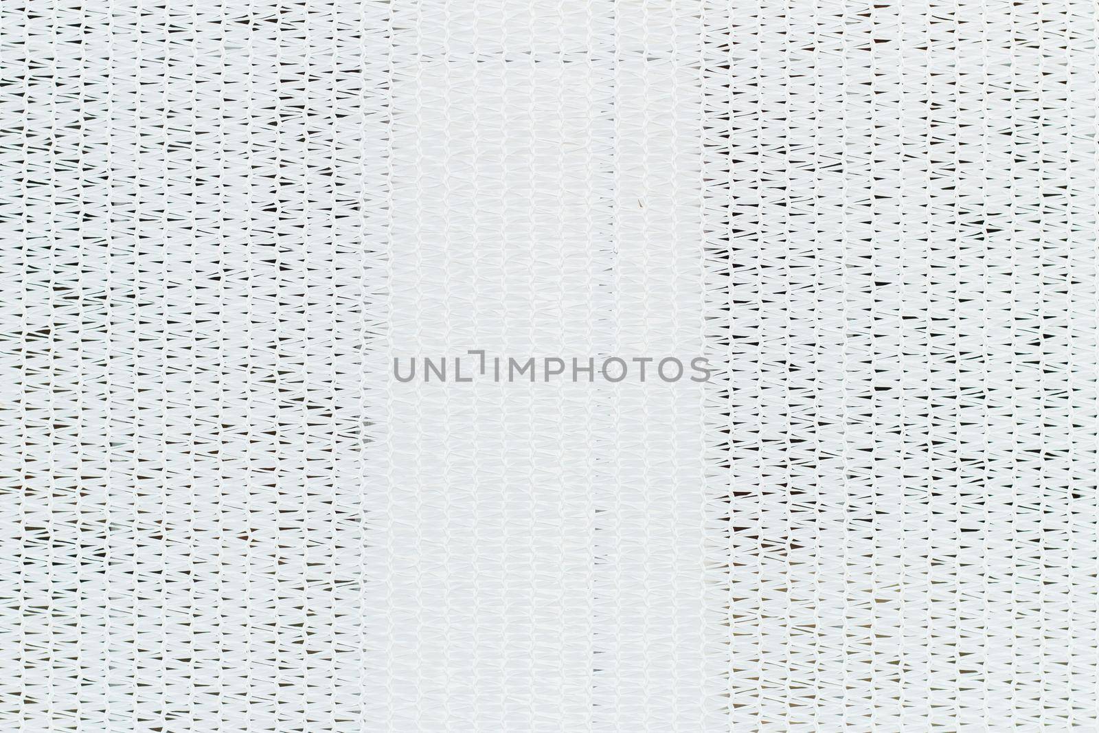 White mesh stretched over the fence. Abstract background