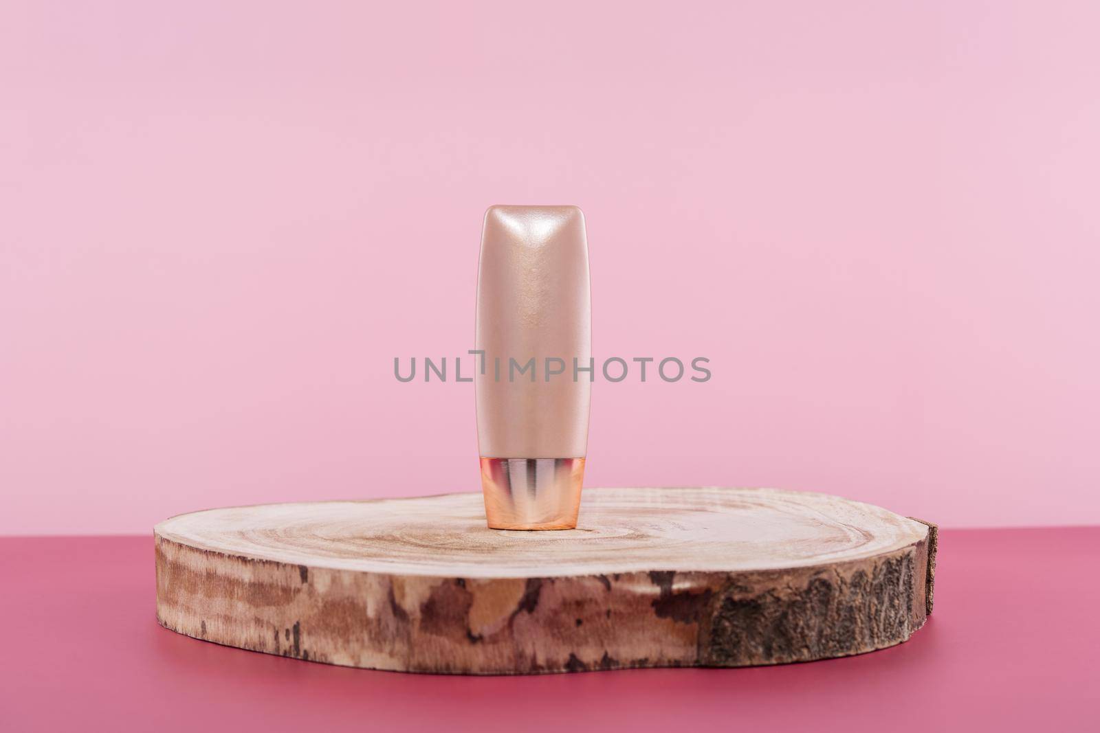 Cosmetic liquid foundation nude cream cosmetics bottle mockup on wooden podium. Beige packaging concealer base product mock up on pink background. Skincare beauty primer by photolime