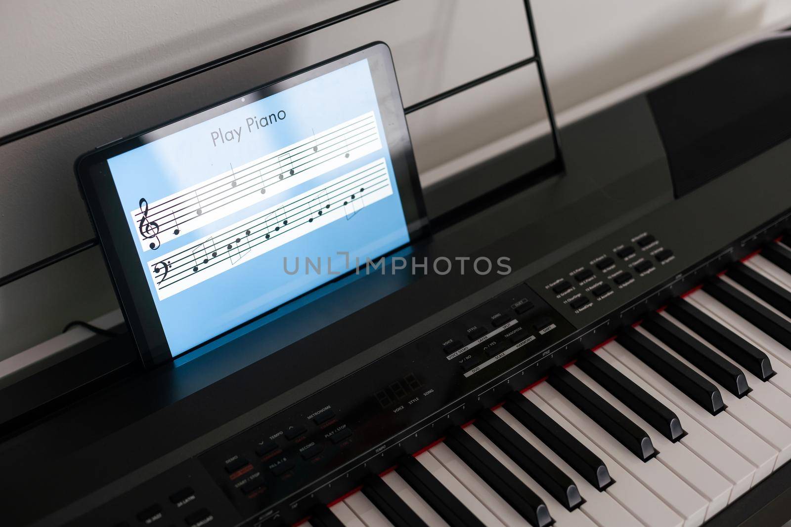 Piano synthesizer app on tablet and musical instrument concept by Andelov13