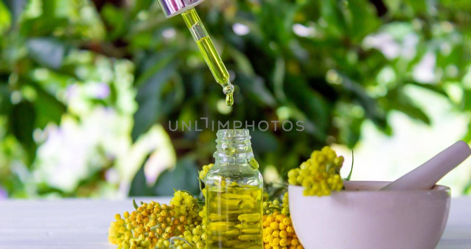 essential oil of tansy in a beautiful bottle on the table. selective focus