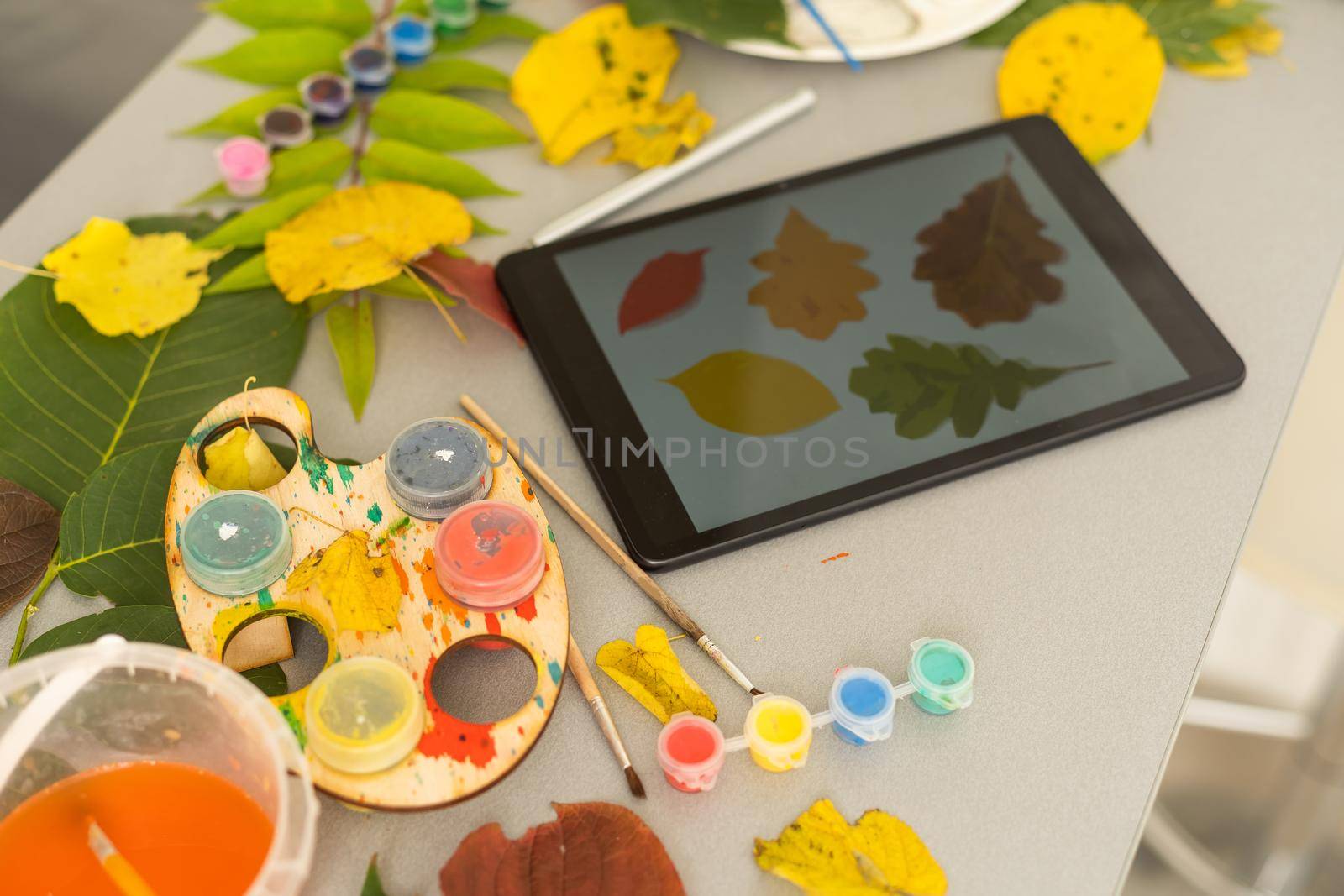 Tablet hot tea checkered blanket apples and autumn leaves on old wooden background Vintage tonning Autumn concept mock up. High quality photo