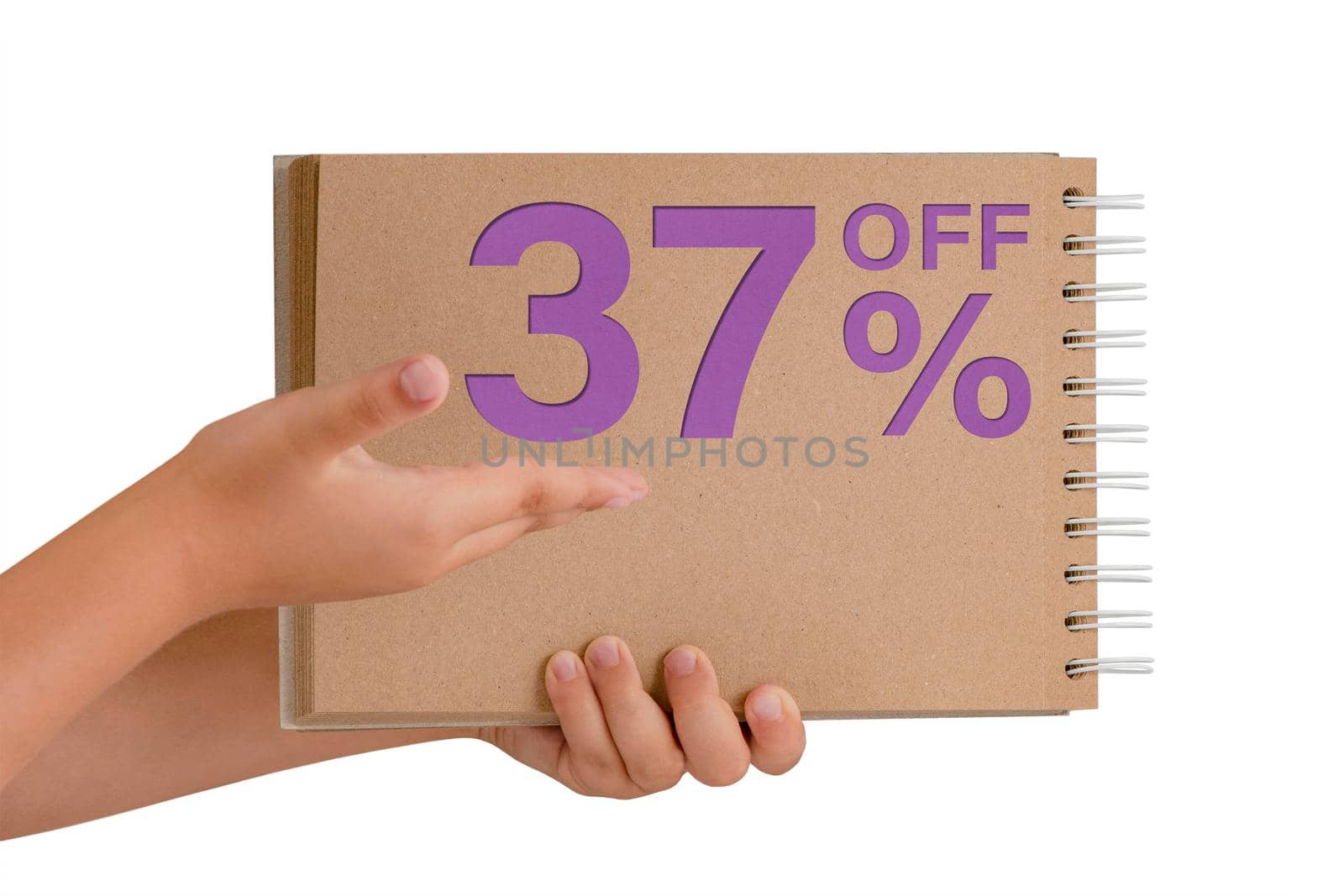 37 percent discount on isolate. Notepad from recycled paper in the hands of a child with text, sale up to 37 percent. The child is holding a notepad demonstrating a big sale