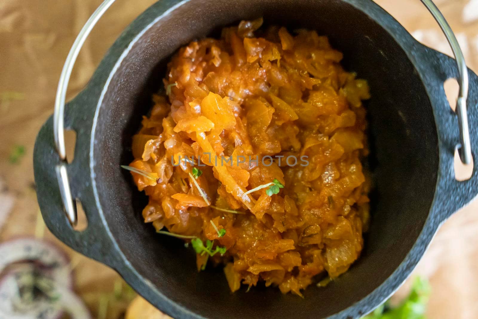 delicious stewed cabbage in a cast-iron pot served in a restaurant by audiznam2609