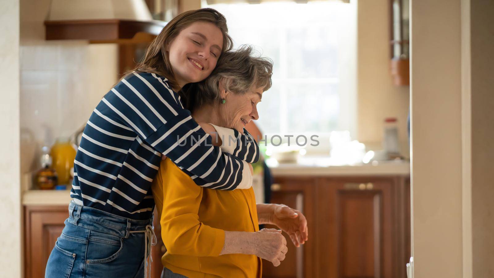 Girl with her grandmother happily spend time together. by africapink