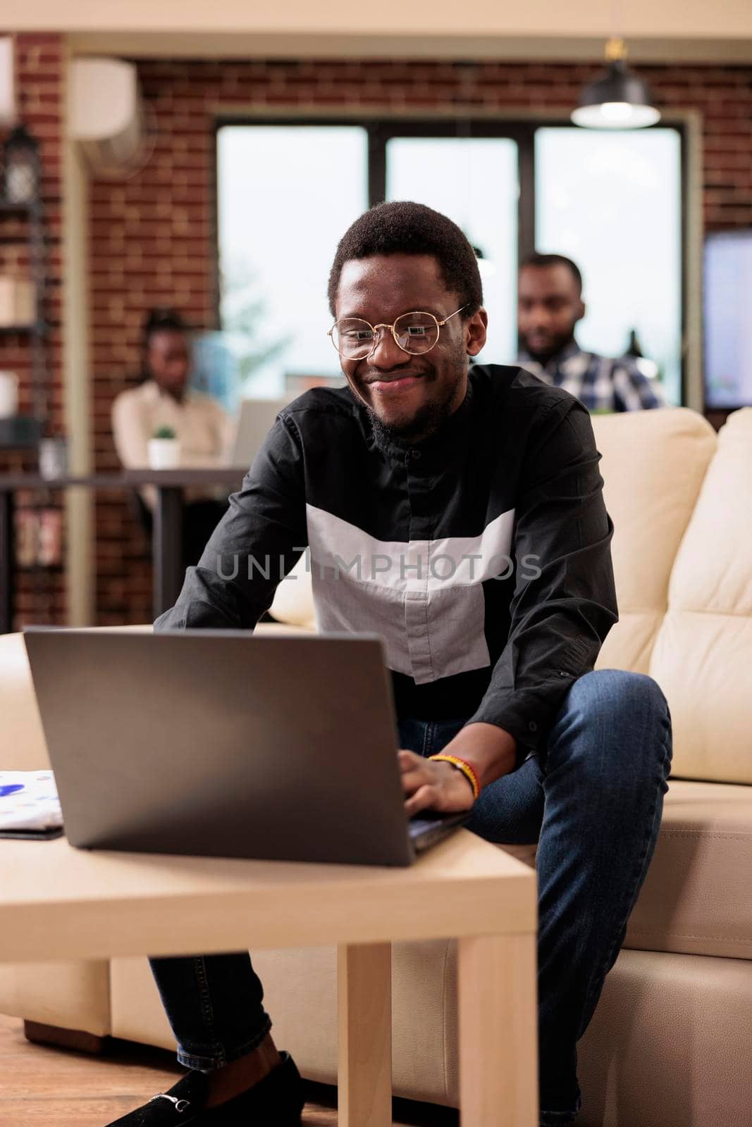 Male freelancer analyzing data on laptop by DCStudio