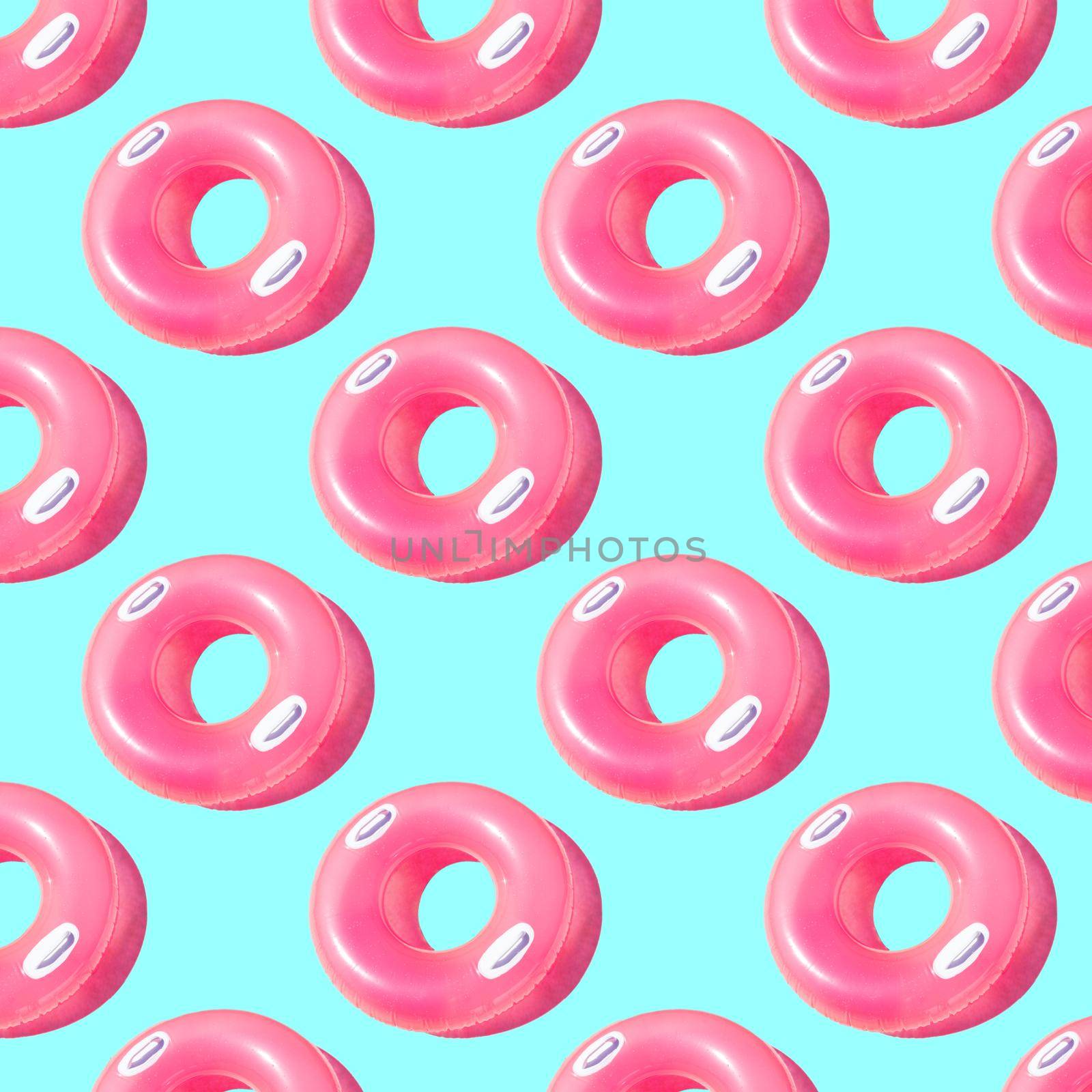 Bright pink inflatable circle with white handles and a shadow on a blue background pattern