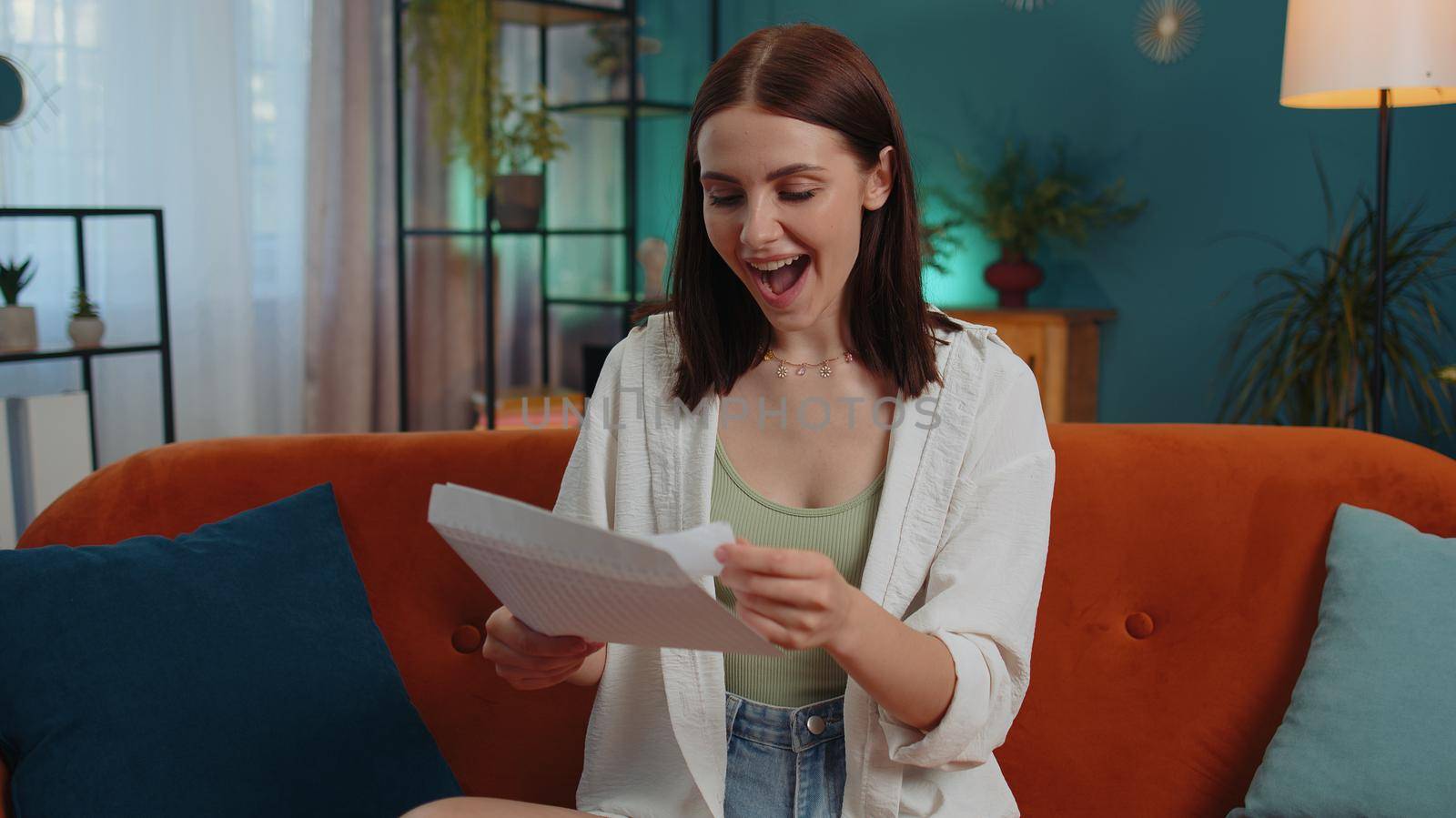 Happy woman open envelope letter, reading it. Career growth advance promotion, bank loan approve, successful admission to university monetary award long-awaited invitation great news, lottery game win