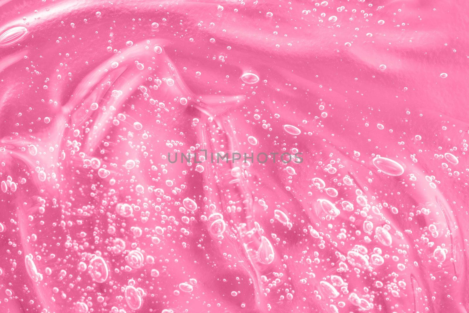 Pink mask smear smudge. Gel serum liquid, cream with collagen and retinol, ceramide sample. Hyaluronic acid toner with retinol and ceramide, jelly texture cosmetic product. Close-up, macro.
