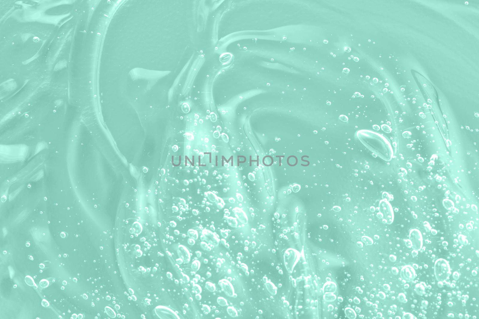 Liquid green oil smudge. The concept of natural cosmetics. Hyaluronic acid clear serum sample. Aloe vera cosmetic gel texture with bubbles background. by photolime