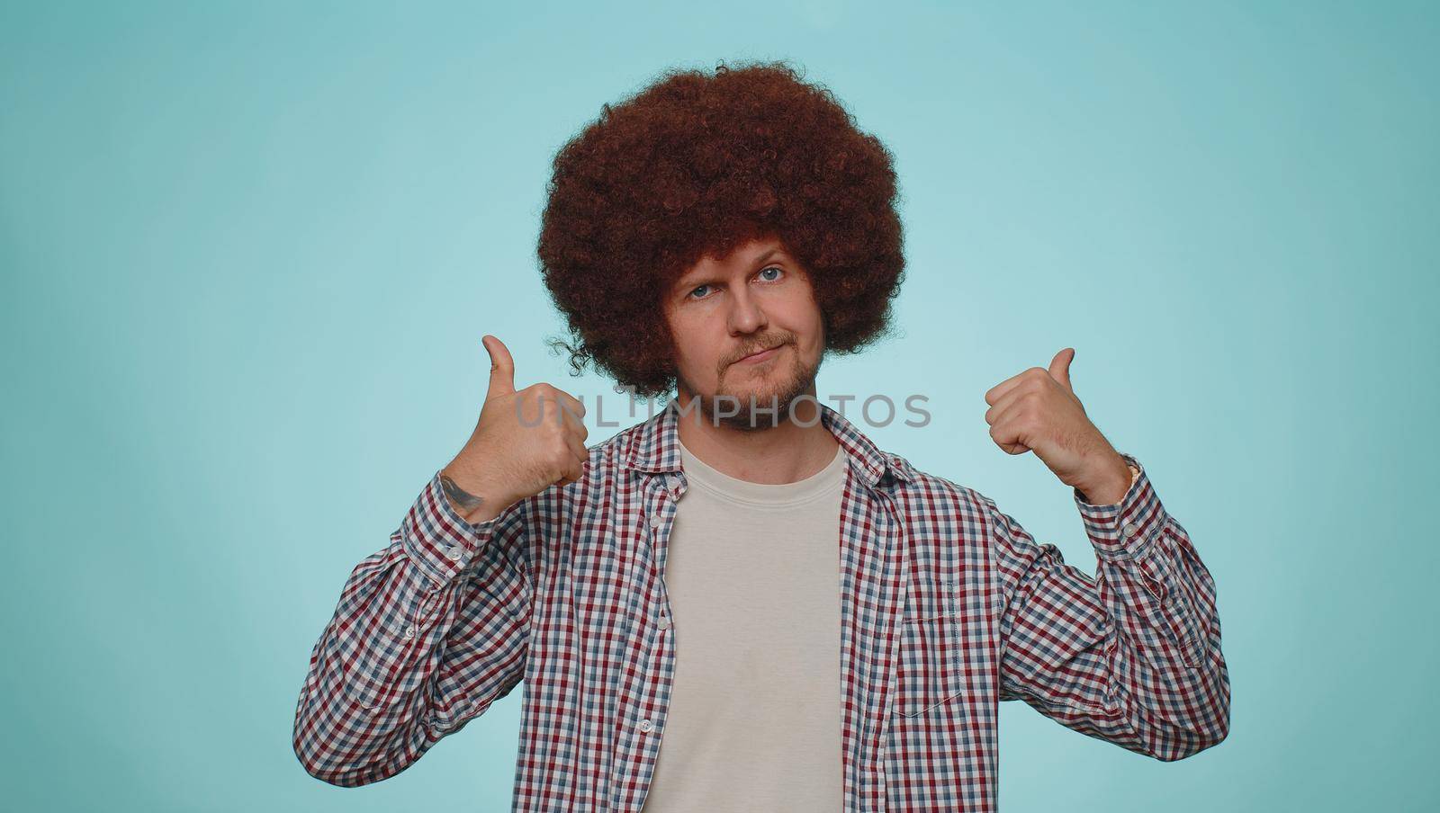 I am the best. Happy satisfied selfish haughty man proud of his victory, bragging own success win achievements, pointing fingers on himself with smile. Young adult guy boy on blue studio background