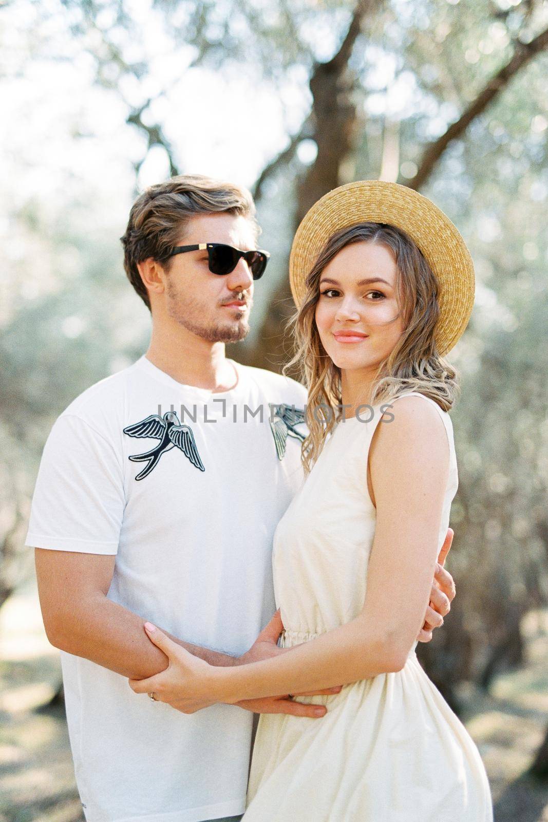 Man and woman hugging near the tree. High quality photo