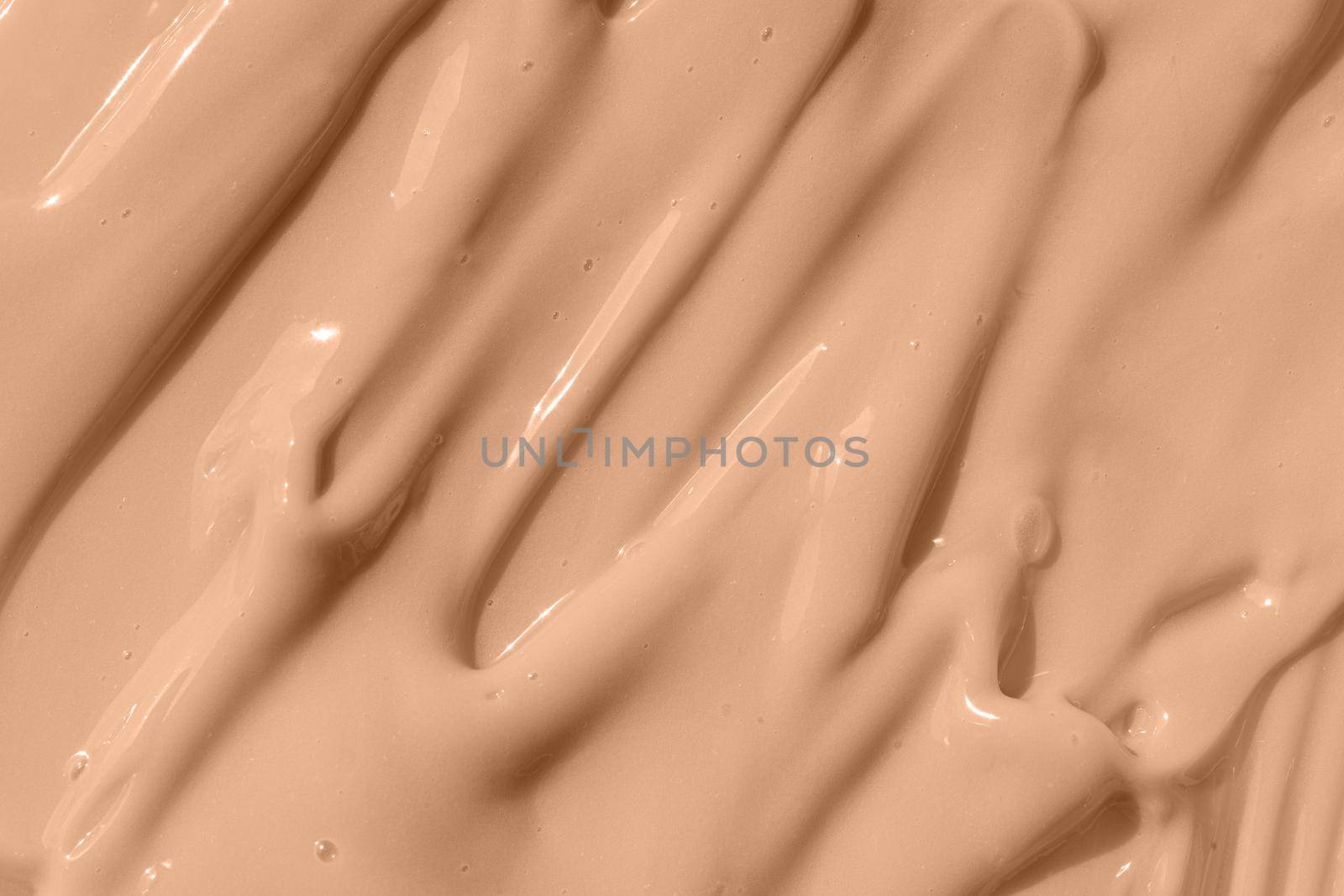 Beige nude liquid foundation texture, concealer smear smudge drop. Make up base, cream textured background. Closeup macro. Cosmetic tonal makeup moisturizer, bb cream swatch sample.