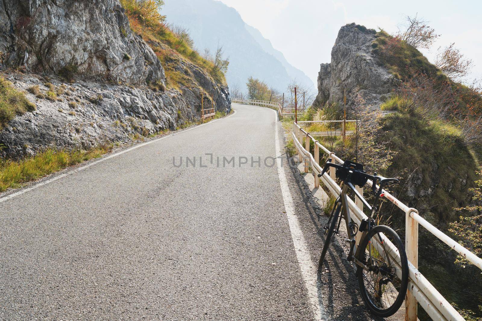 Bicycle on mountain road, mountainbike in the alp mountains autumn landscape. Extreme sport and biking concept, outdoors lifestyle trail