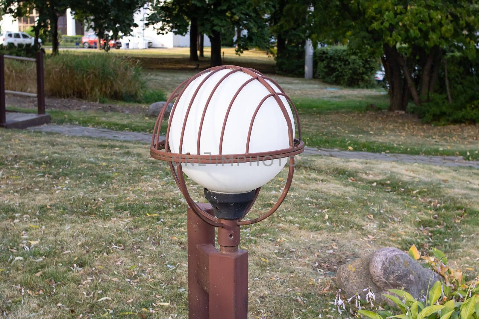 Rusty street lamp in the park close up