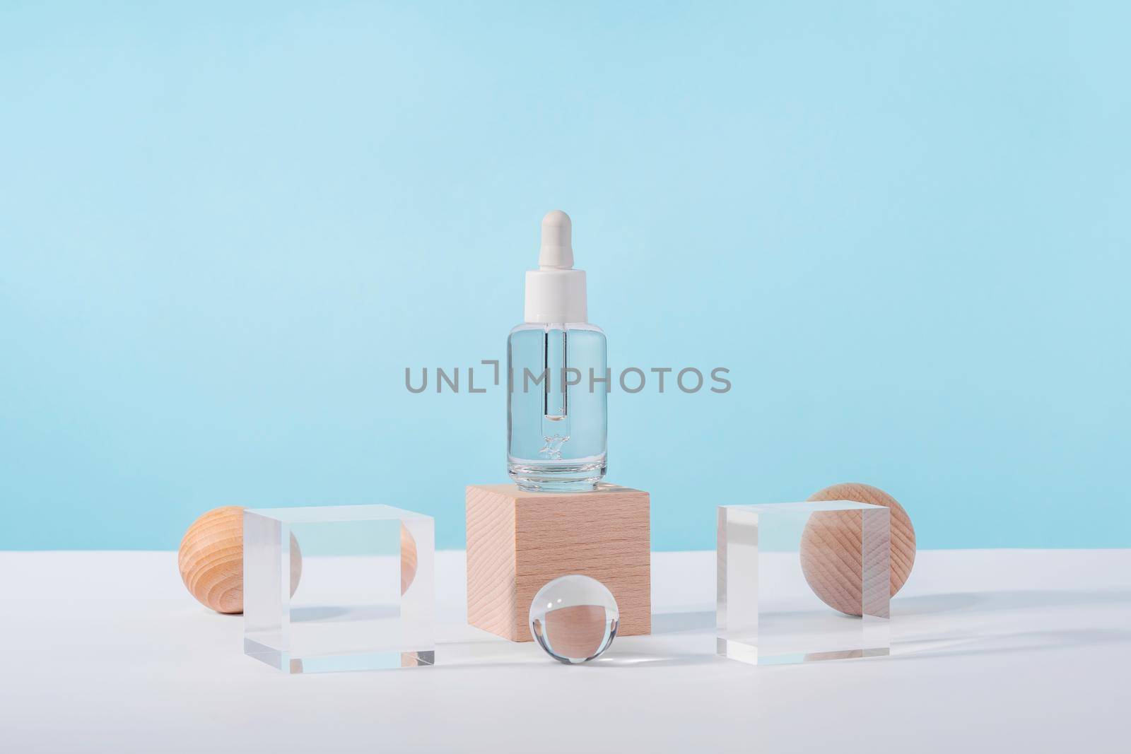 Serum cosmetic bottle with peptides and retinol on acrylic and wooden blocks on pink background. Oil cosmetics transparent product packaging with stylish props. Serum dropper mockup on pedestal by photolime