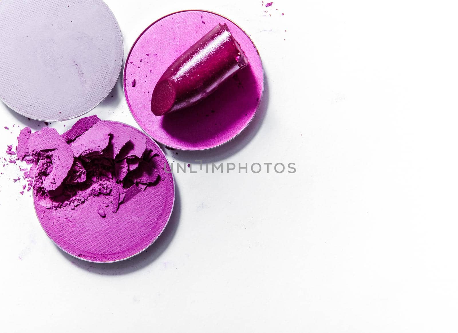 Beauty texture, cosmetic product and art of make-up concept - Crushed eyeshadows and lipstick isolated on white background