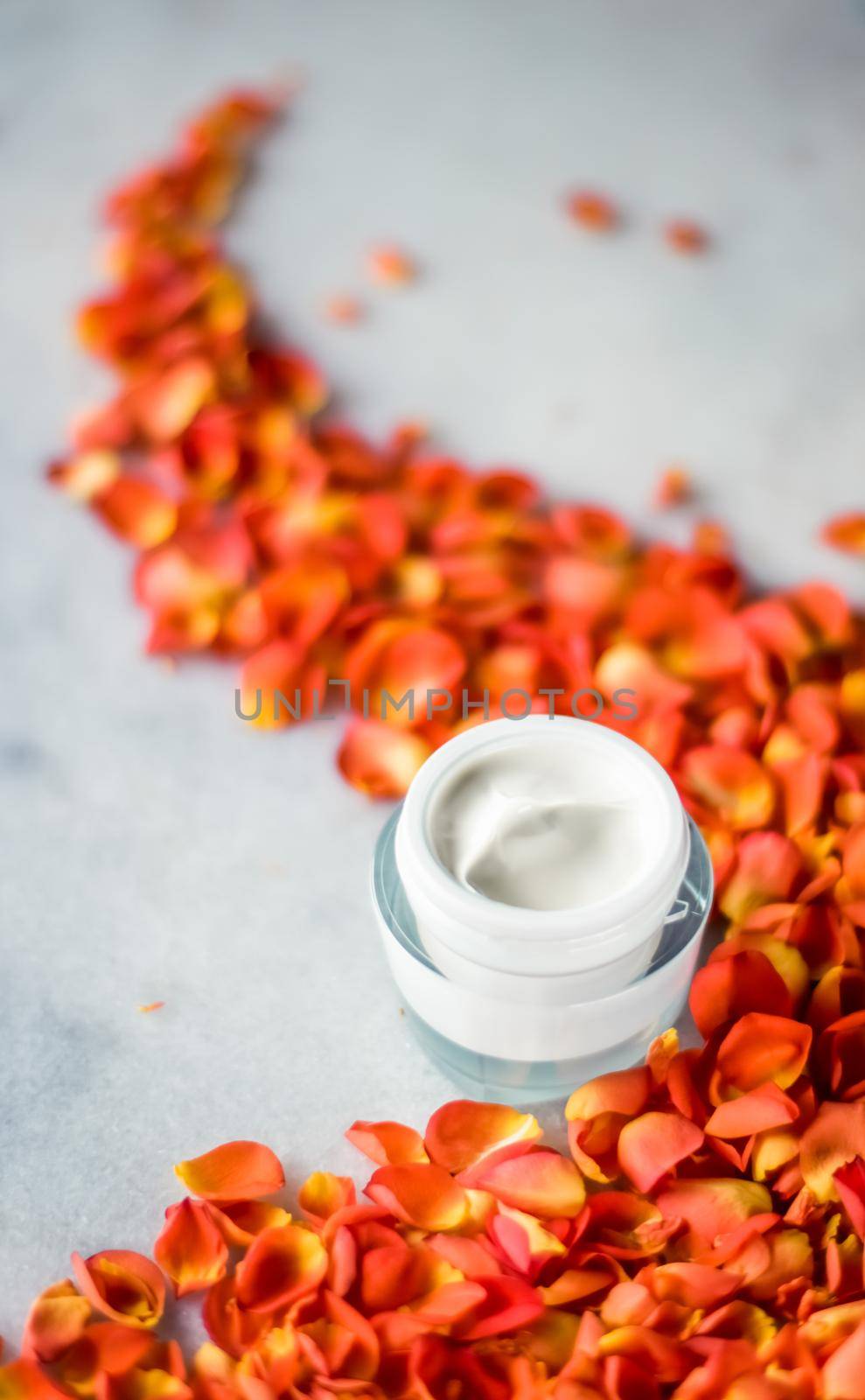 Facial treatment, anti aging skincare and spa concept - Beauty face moisturizing cream and flower petals on marble, luxury cosmetic product