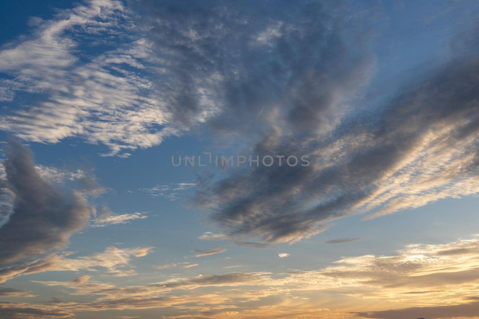 Cloudscape view of clouds and sky at sunset by Bilalphotos