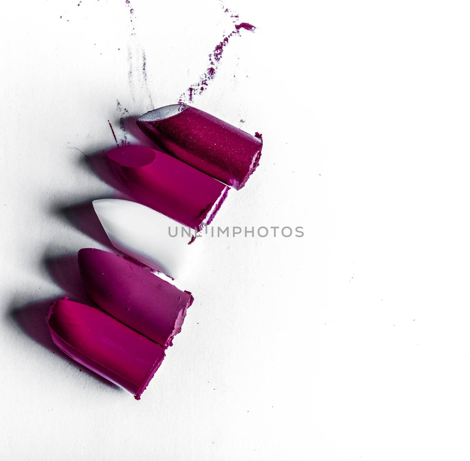 Beauty texture, cosmetic product and art of make-up concept - Cutted lipstick close-up isolated on white background