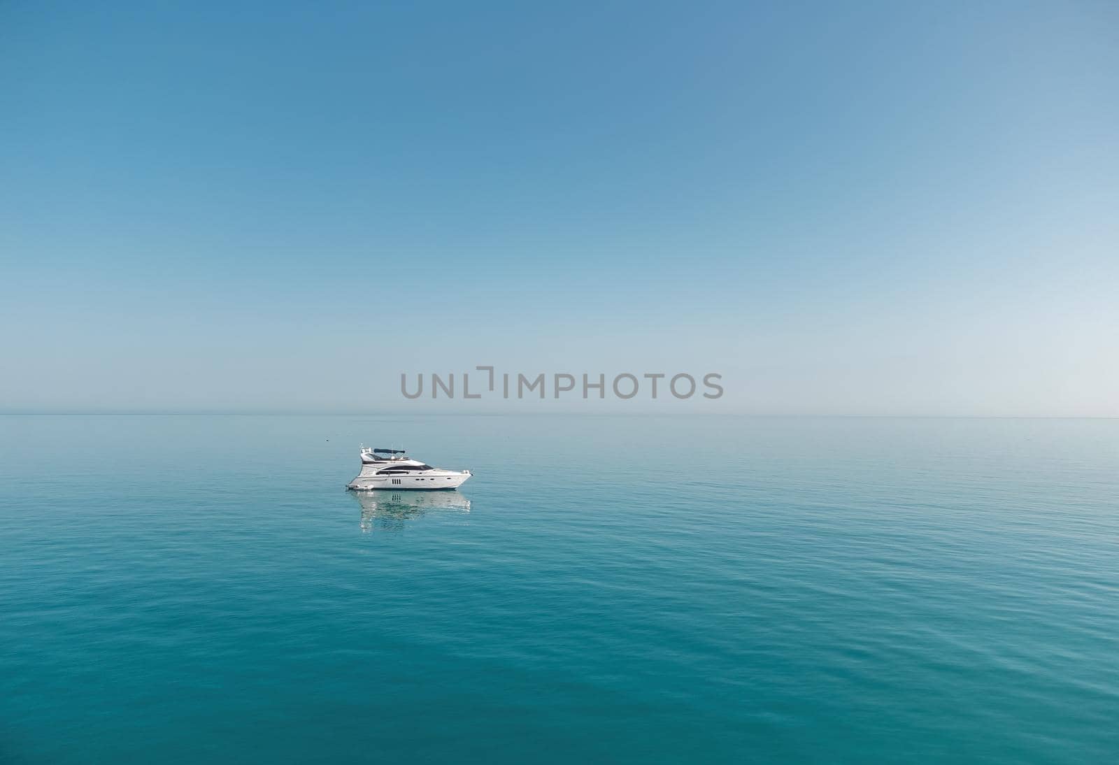 Aerial boat race. Luxury cruise trip. View from above of white boat on deep blue water. Aerial view of rich yacht sailing sea. Motor boat racing wave. Summer journey on luxury ship