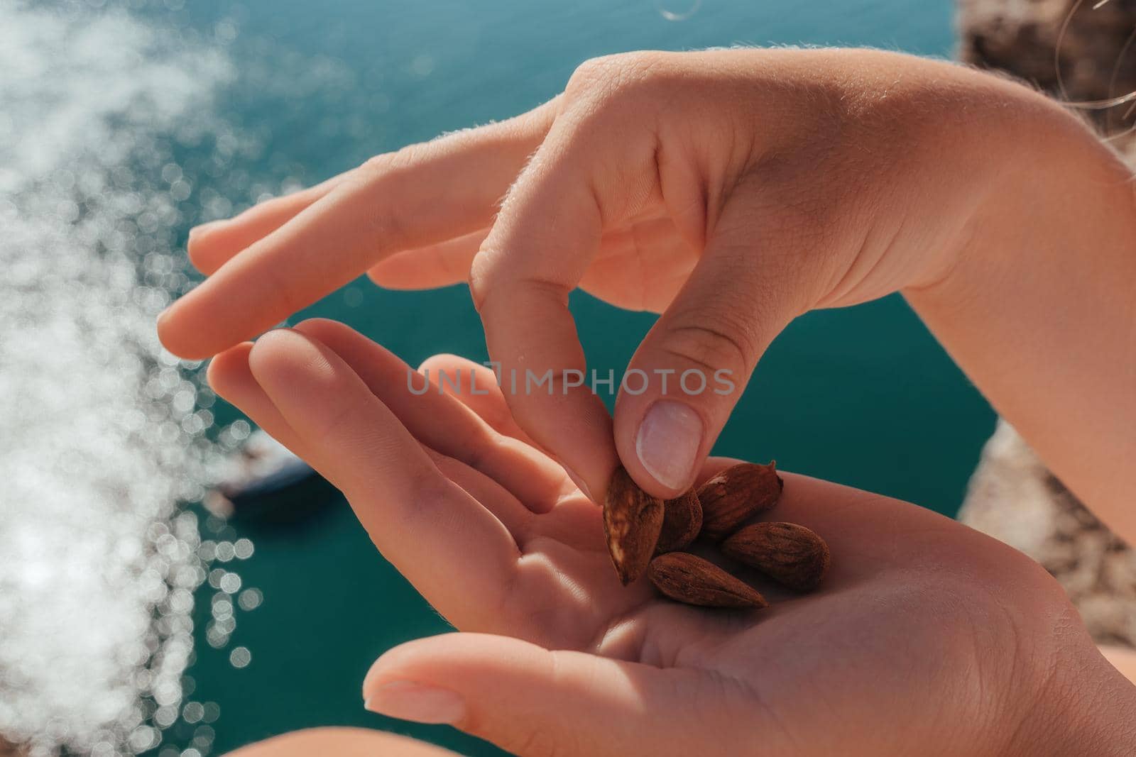 Unrecognizable caucasian woman eating young milky almond nuts. Healthy vegan food
