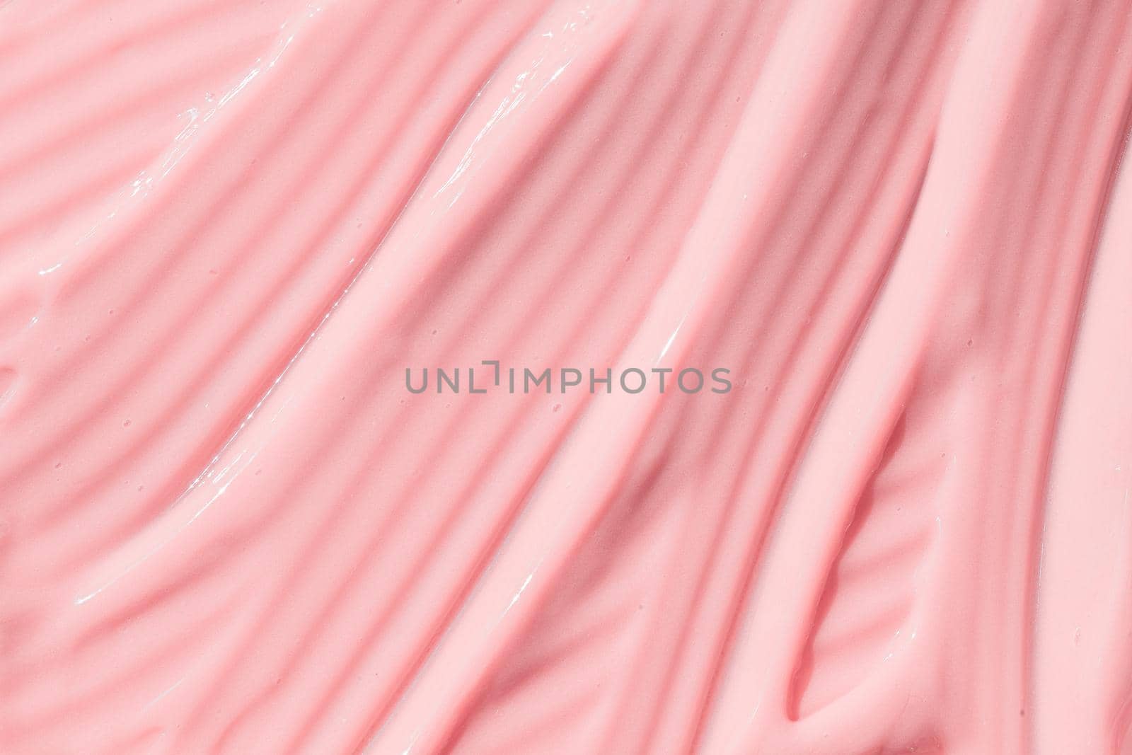 .Creamy pink skincare lotion mousse product closeup. Peach cream, moisturizer spread, sunscreen cosmetic smear background. Moisturizing beauty creme, balm swatch, pink paint, yogurt texture by photolime