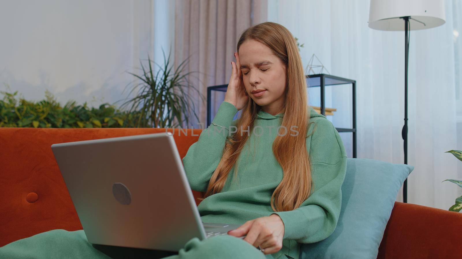 Tired student girl child kid freelancer use laptop, suffering from headache problem tension and migraine, stress. Young woman works on notebook, sends messages, makes online purchases, watching movies