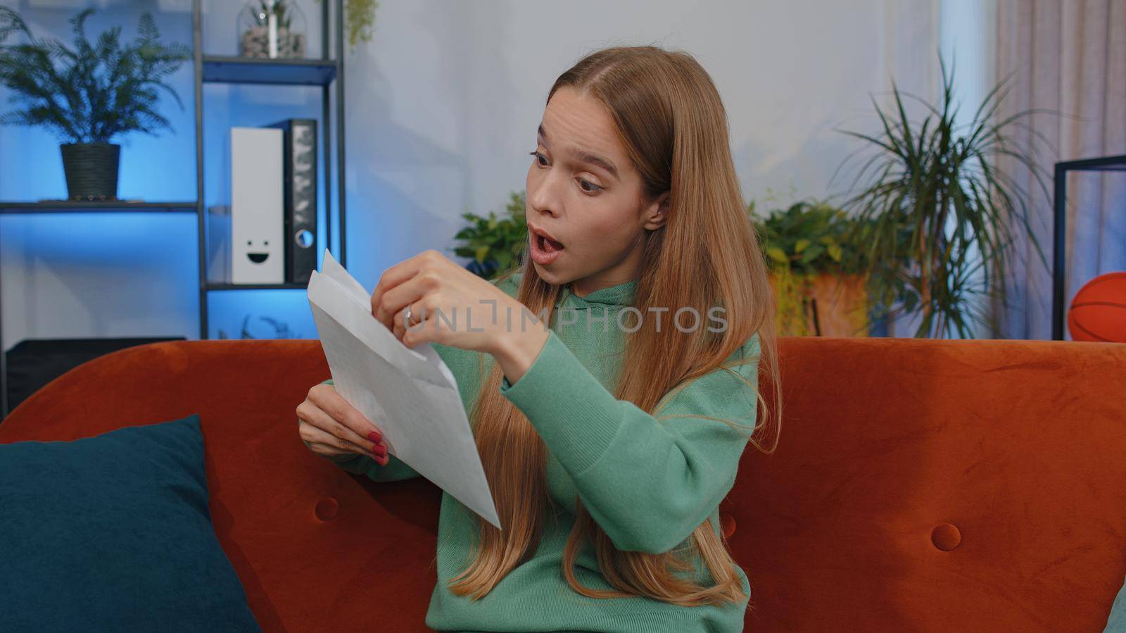 Happy girl open envelope letter, reading it. Career growth advance promotion, bank loan approve, successful admission to university monetary award long-awaited invitation great news, lottery game win