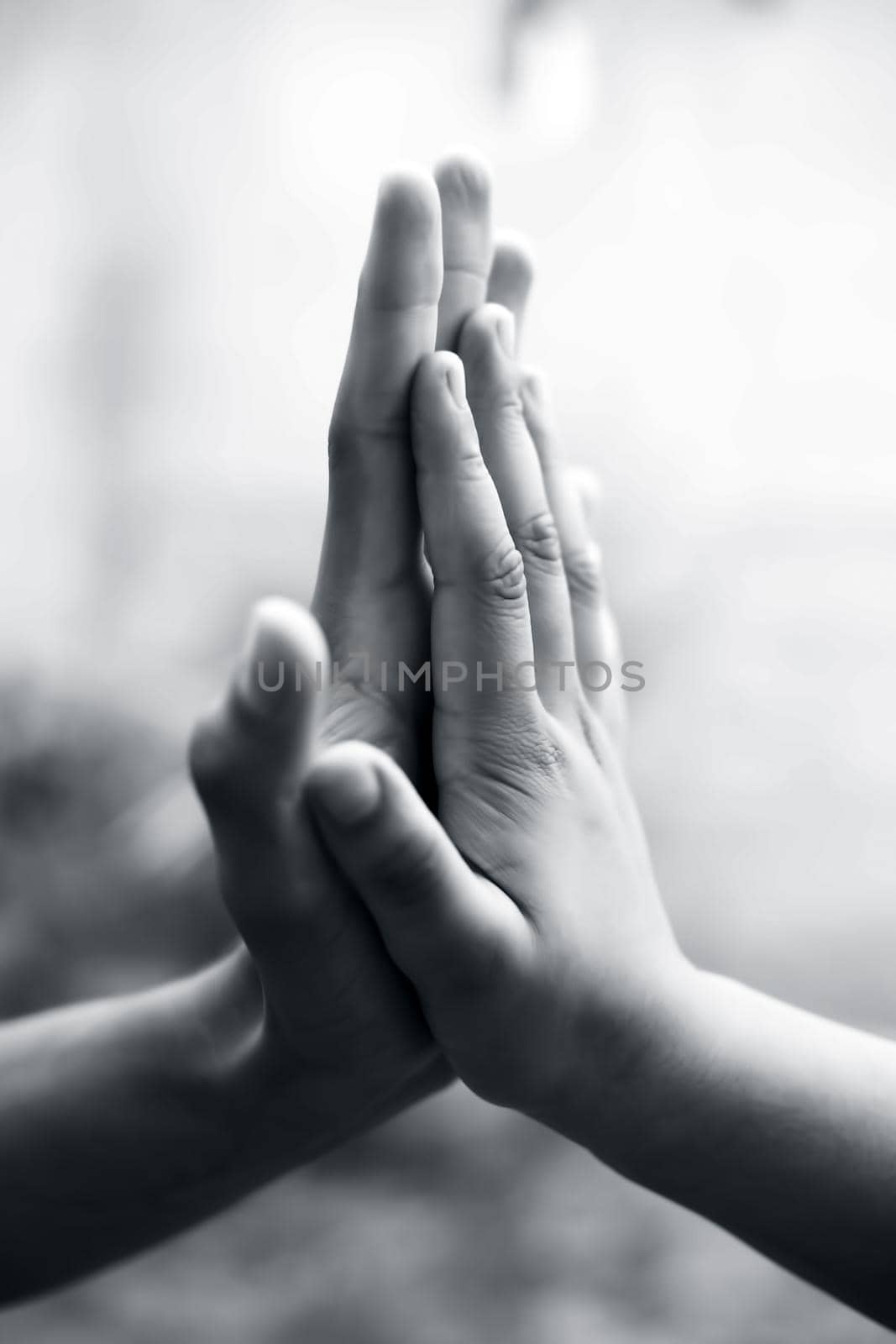 Child hand comparing her hand with her father shot with blurred bokeh background and the concept of Father’s day ( 16th June). by mirzamlk