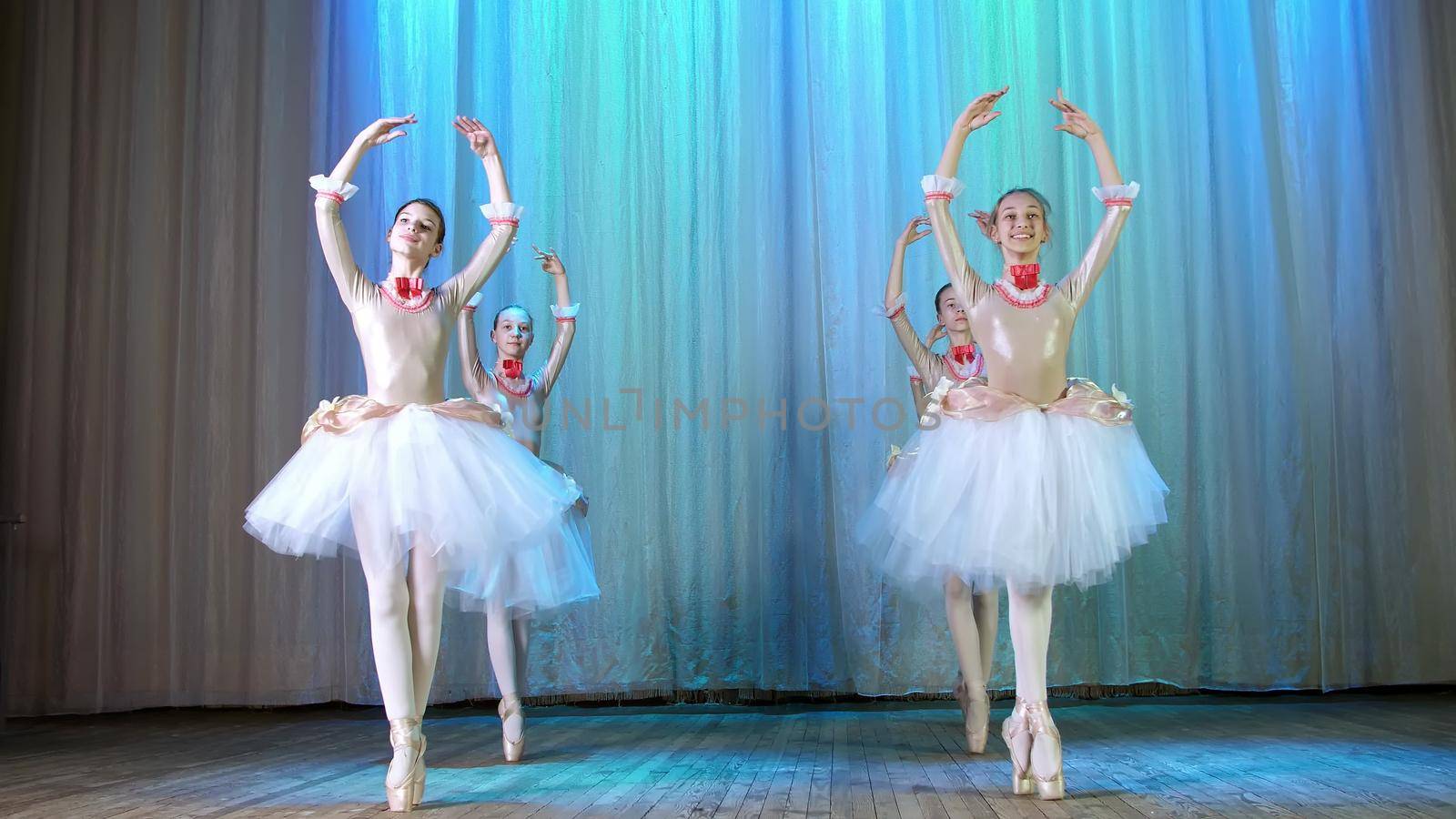 ballet rehearsal, on the stage of the old theater hall. Young ballerinas in elegant dresses and pointe shoes, dance elegantly certain ballet motions, pass, scenic bow. High quality photo