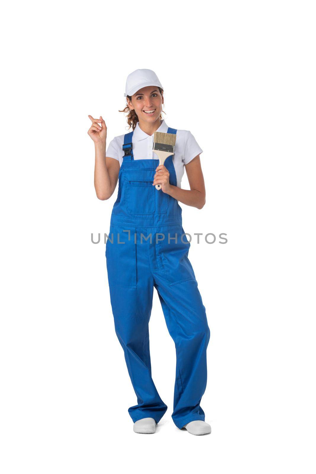 Female house painter with paint brush pointing with finger alise studio isolated on white background