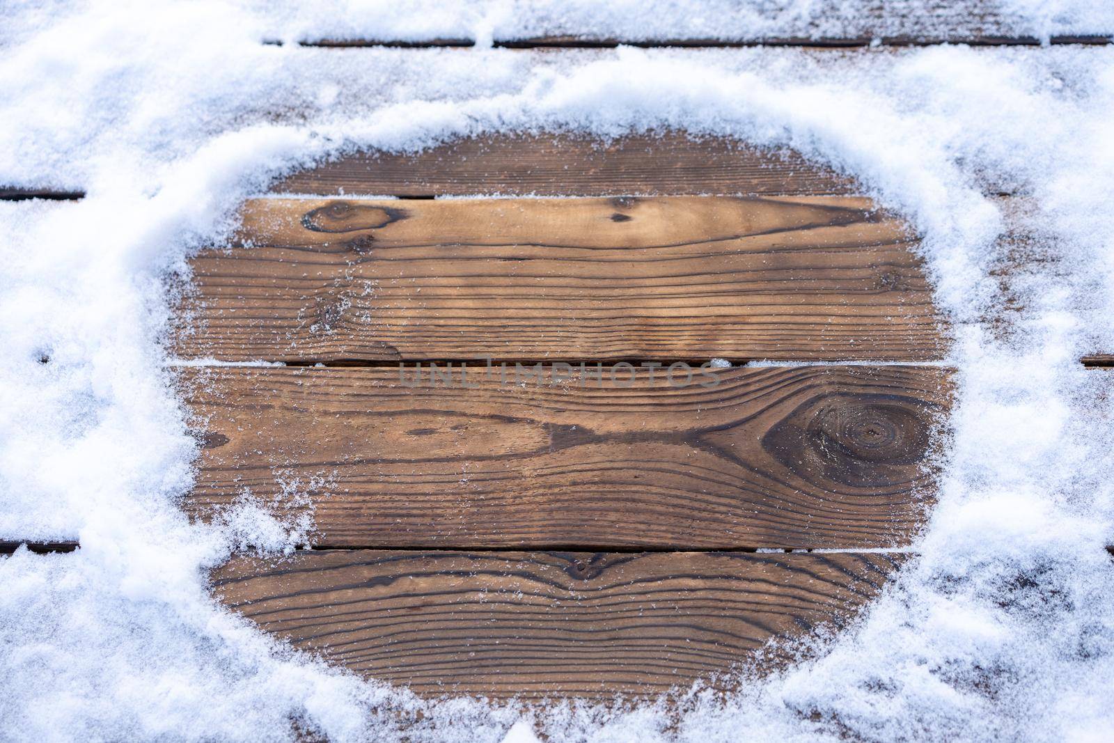 Winter background. Empty wooden plank with snowy border, copy space for text Wood table to. For product display Christmas time mock up