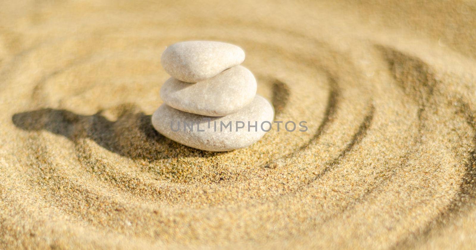 zen meditation stone in sand, concept for purity harmony and spirituality, spa wellness and yoga background, harmony