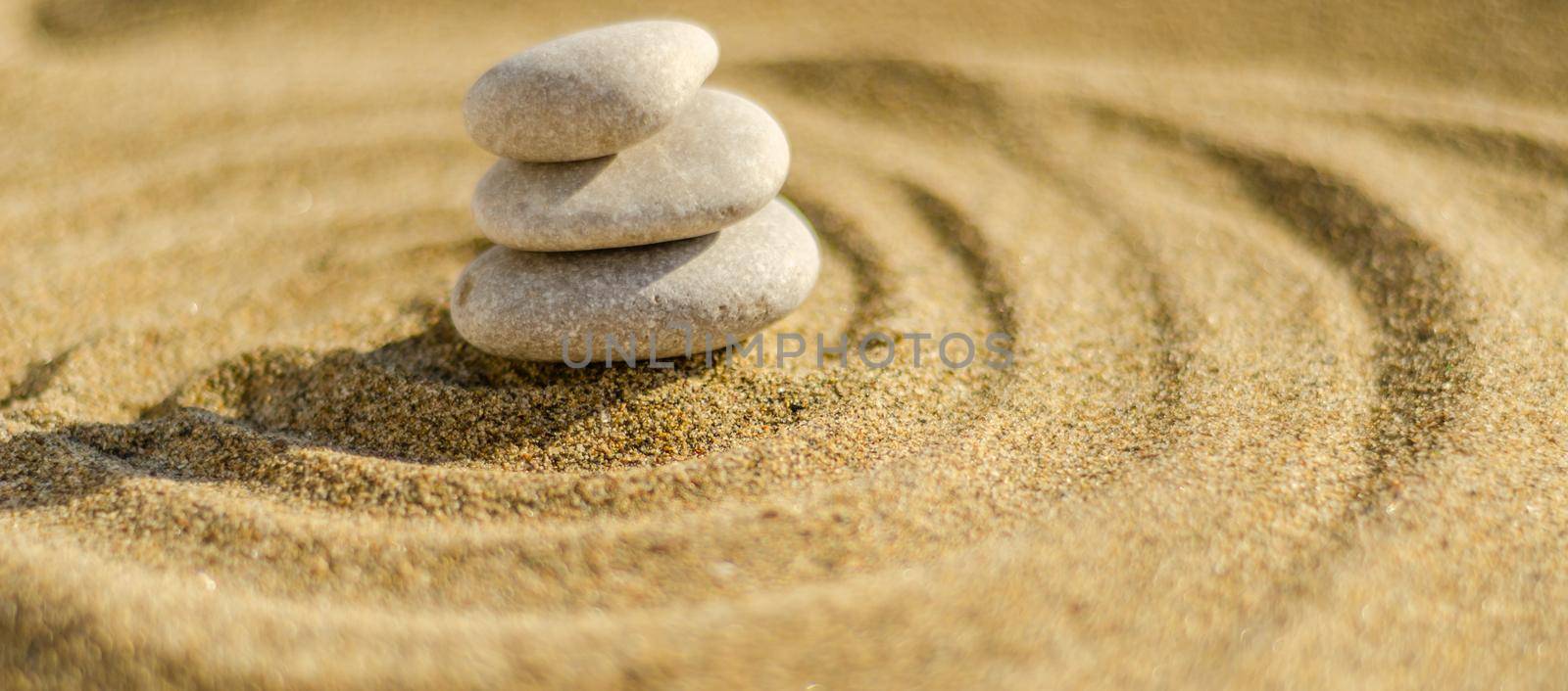 zen meditation stone in sand, concept for purity harmony and spirituality, spa wellness and yoga background by Q77photo