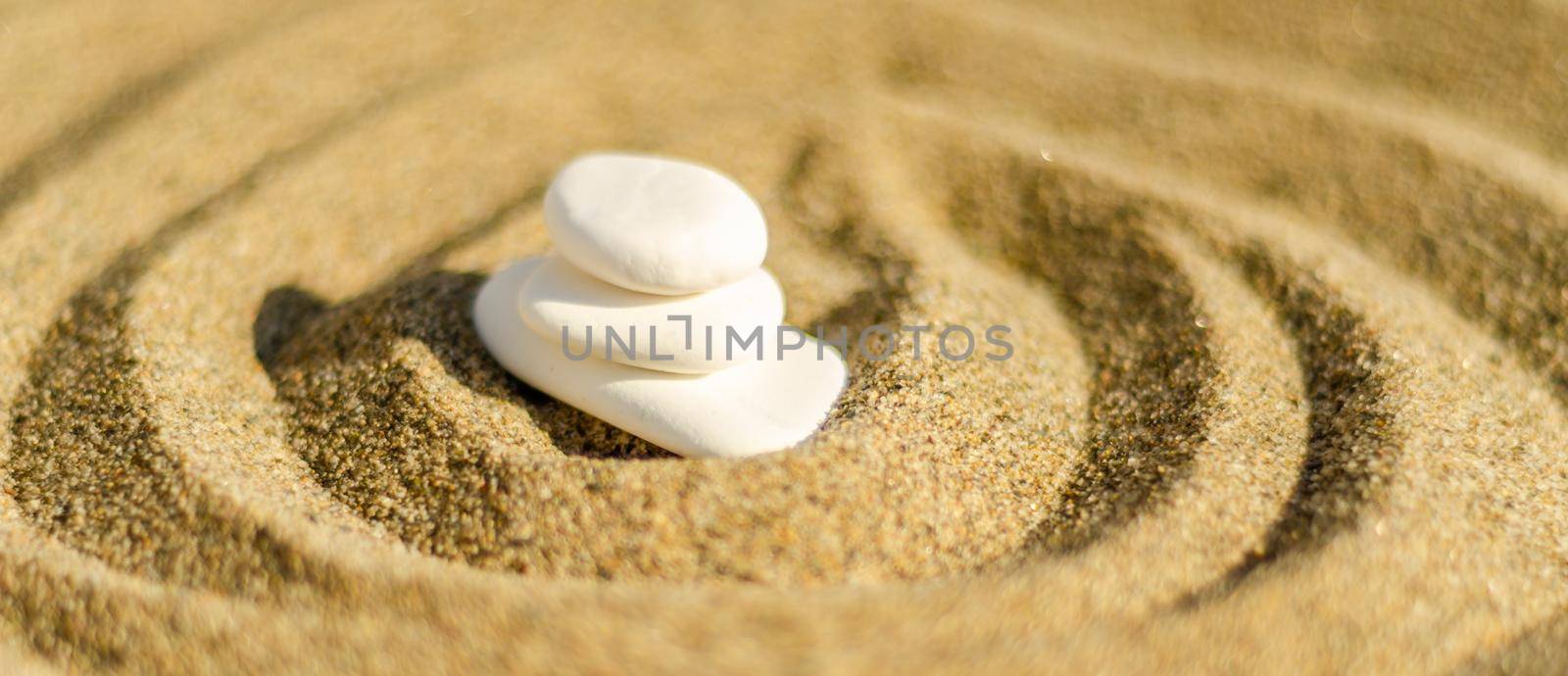 zen meditation stone in sand, concept for purity harmony and spirituality, spa wellness and yoga background, harmony