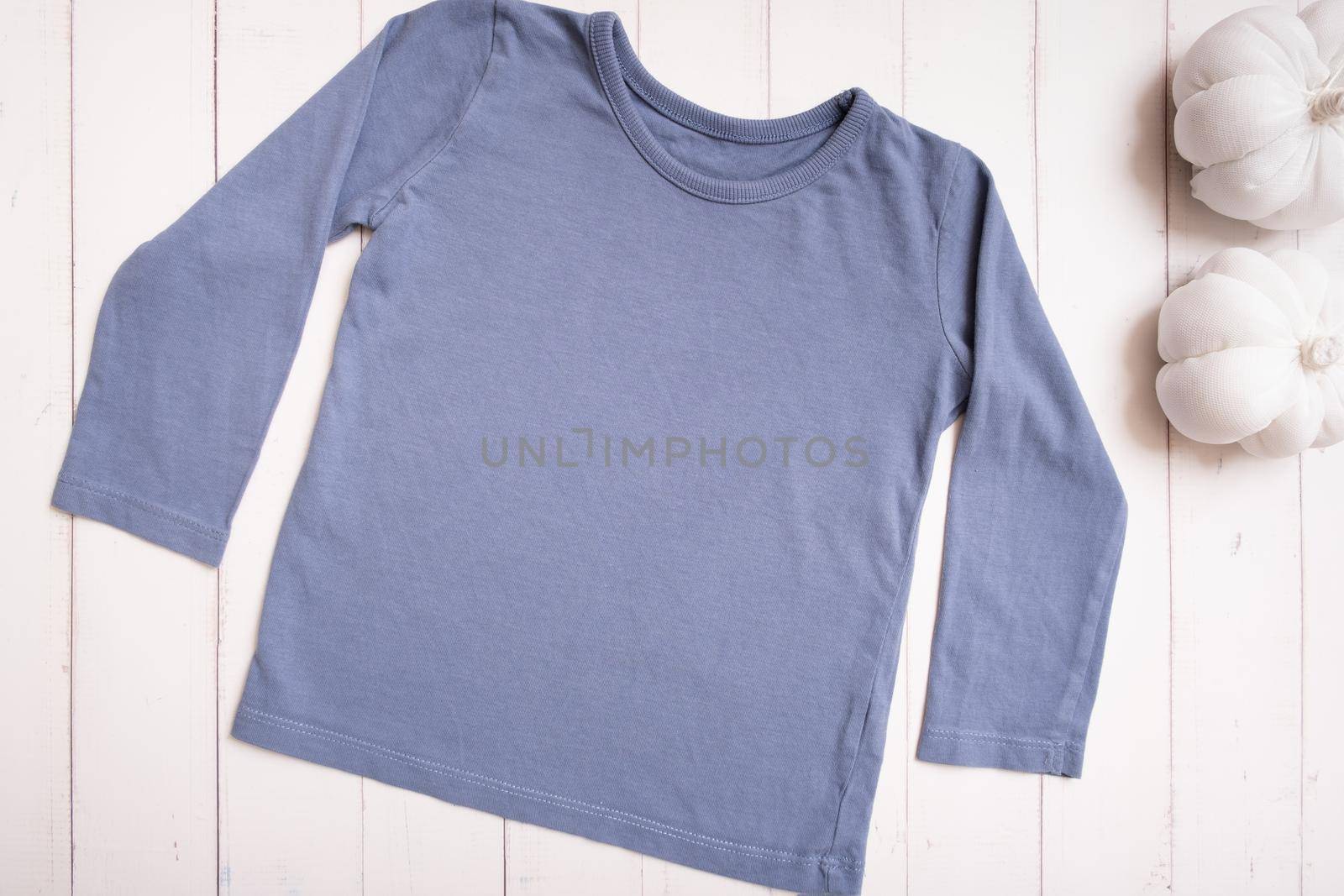 Grey baby shirt top view. Mock-up for logo, text or design on wooden background. Flat lay child clothes with pumpkins. by ssvimaliss