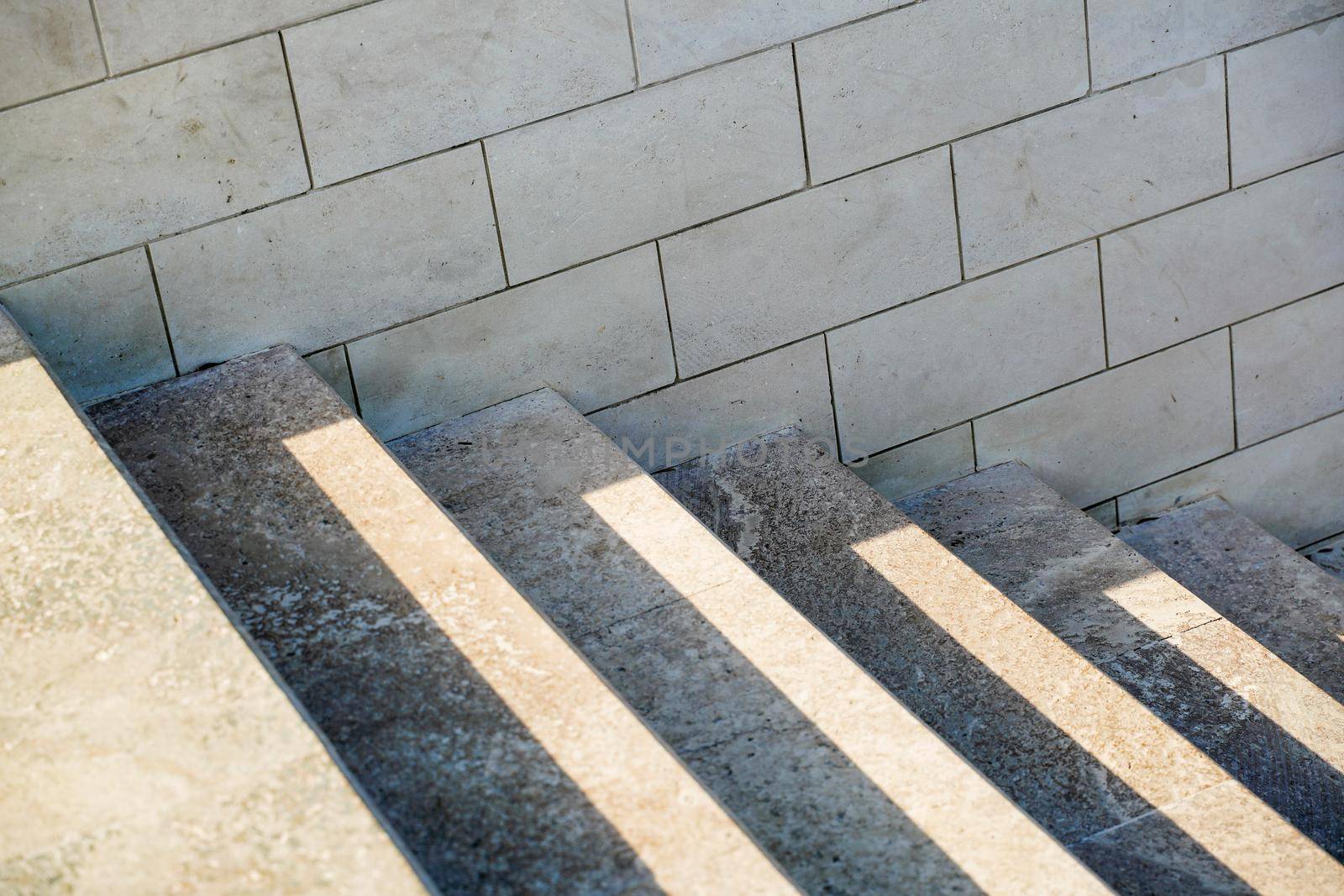 Staircase in the city, black and white pattern on the stairs on a sunny day. by Matiunina