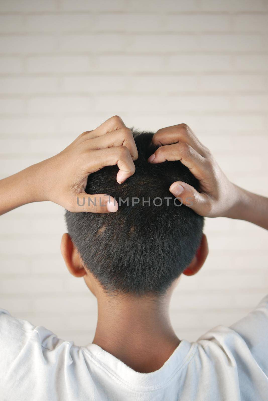 teenage boy Scratching Head Against black background