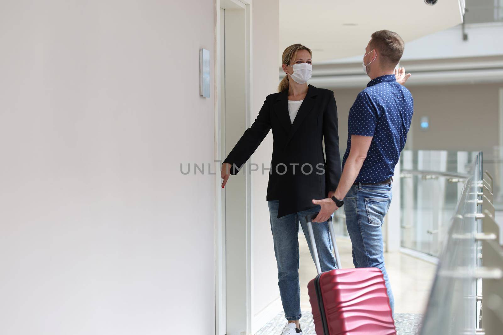 Two tourists observe sanitary rules during pandemic and check into room in hotel room by kuprevich