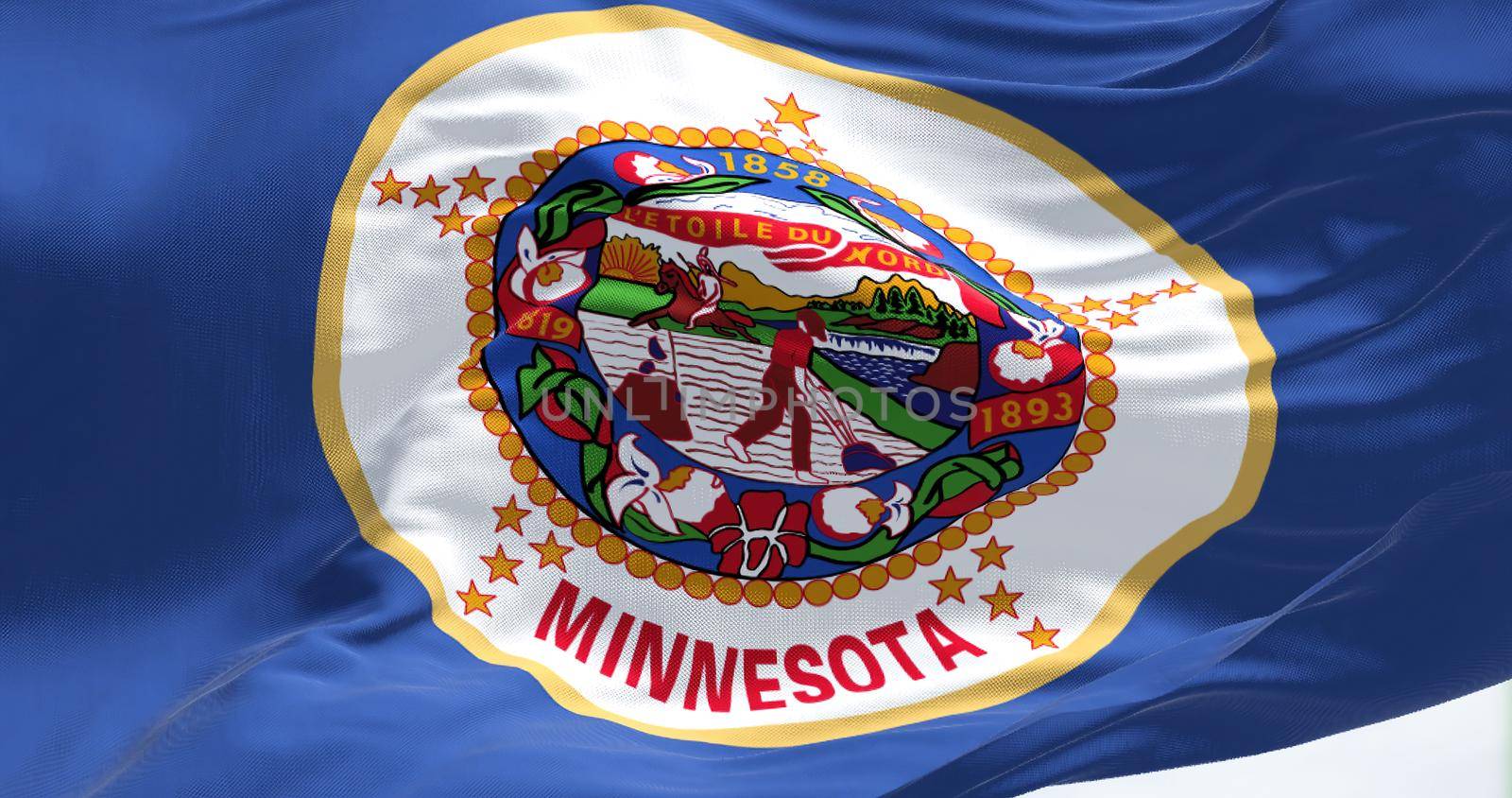 Close-up view of the Minnesota state flag waving. Minnesota is a state in the upper midwestern region of the United States. Fabric textured background