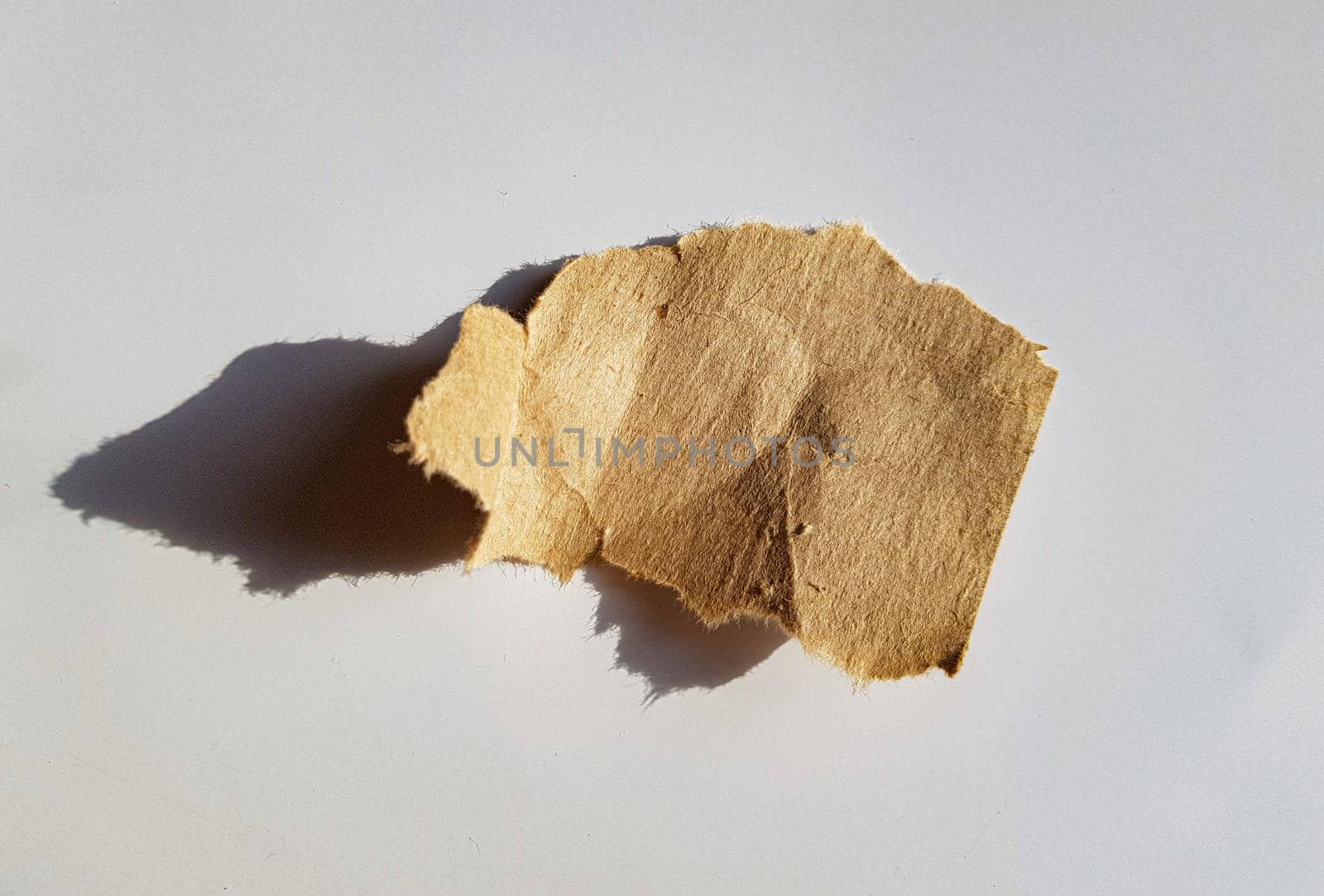 Recycled paper craft stick on a white background. Brown paper torn or ripped pieces of paper isolated on white with clipping path.